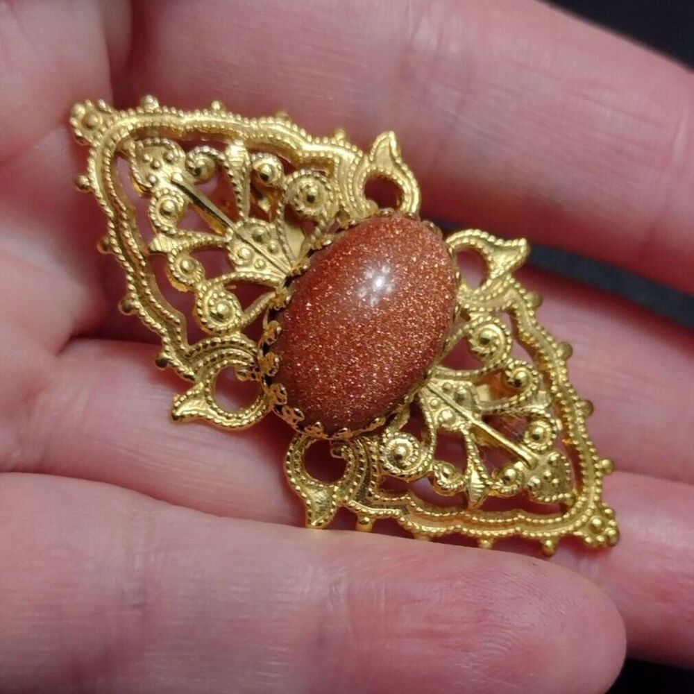 Vintage gold tone oval goldstone brooch